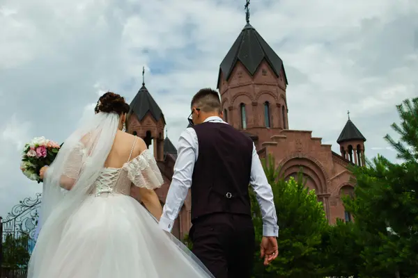 a bride and groom walking toward a church from Life Church Leander in Leander, TX - church near me