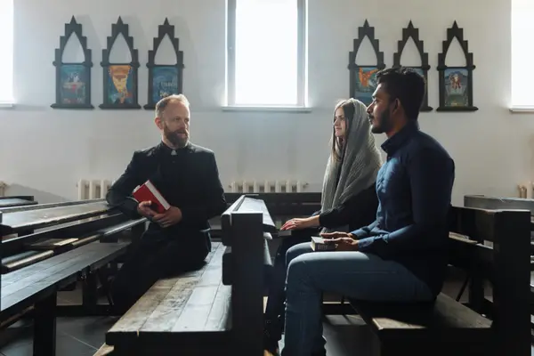 a minister talking to a couple inside the church from Life Church Leander in Leander, TX - Youth Ministry
